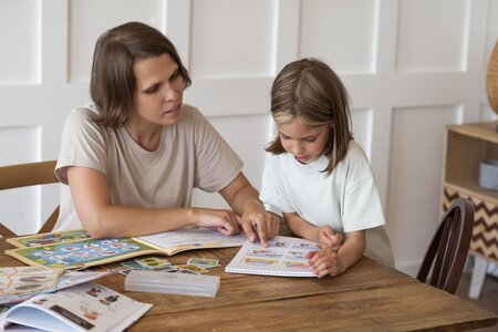 woman-helping-girl-study-medium-shot